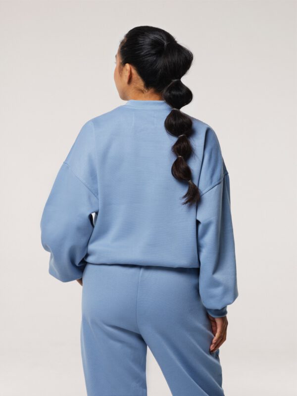 Back view of black-haired petite wearing a Blue Jogging Set in size small