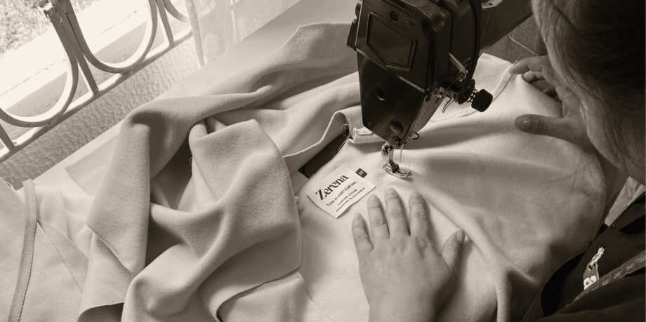 Ethical production: Patricia sewing a Zerena label in a sweater