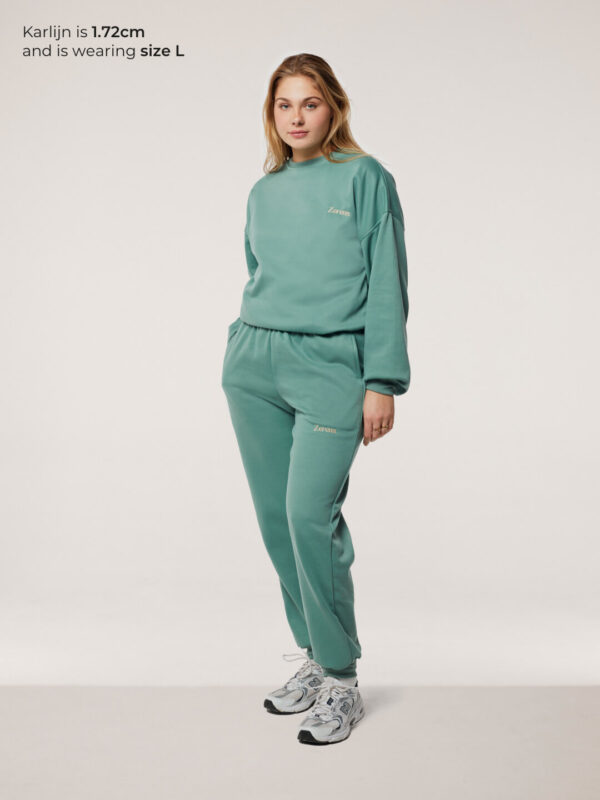 blonde woman wearing green jogging set size L